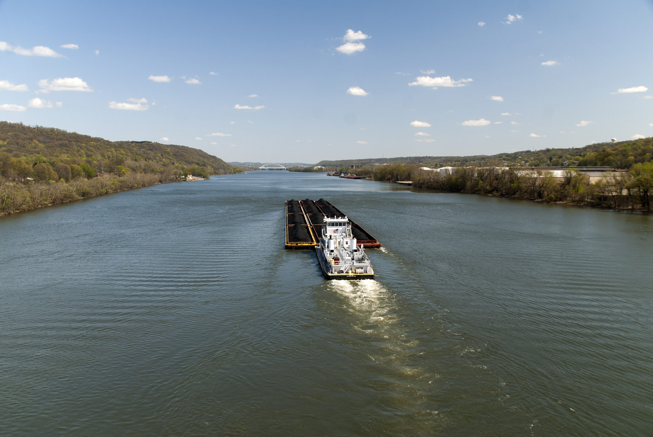 A coal freighter moves upriver