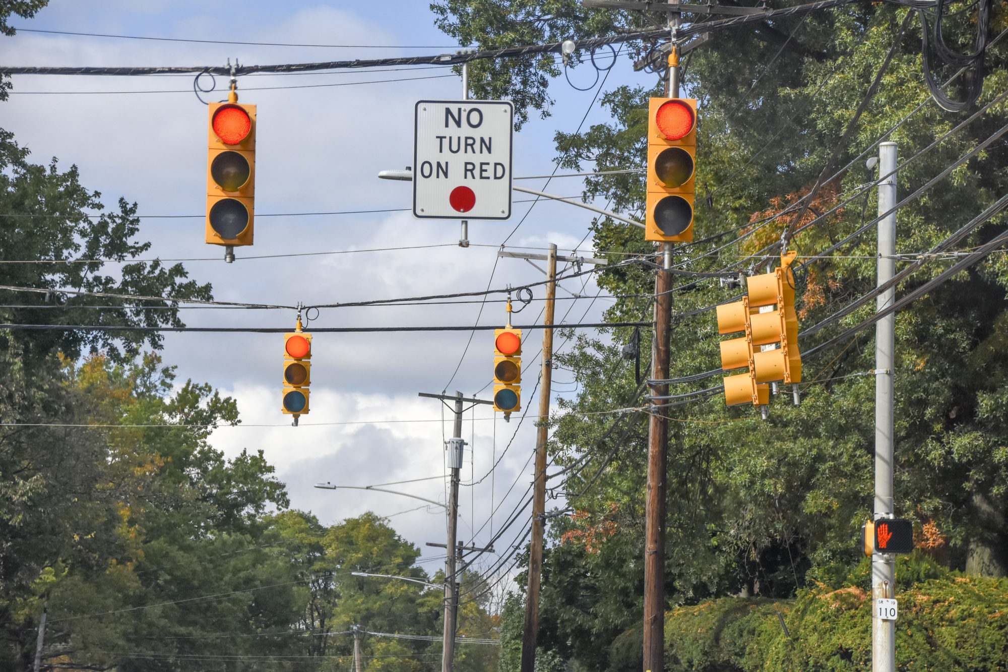 Close up of Red Traffic Lights. A "No Turn On Red" Sign is present.